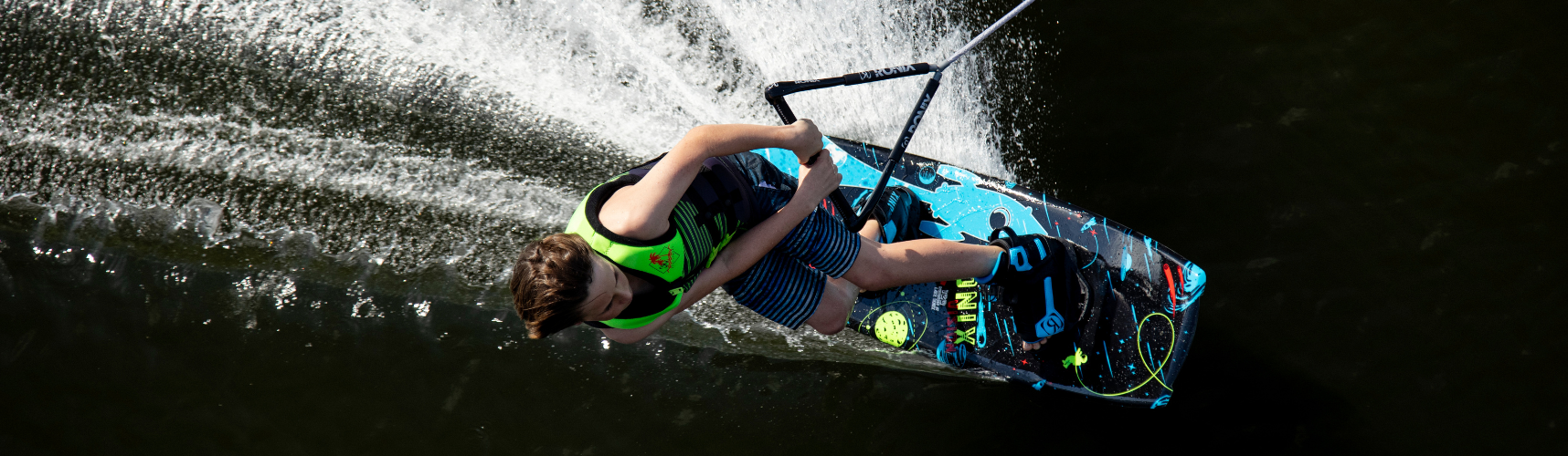 Kid riding a 2024 Ronix Vision Beginner Wakeboard