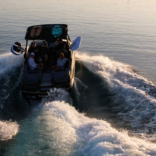 Boat pulling a man on a Ronix Koal Fish wakesurf board